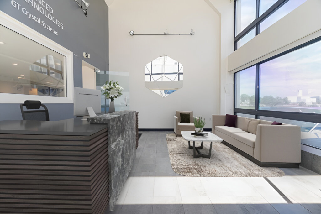 Large lobby area with reception desk, couch, and table